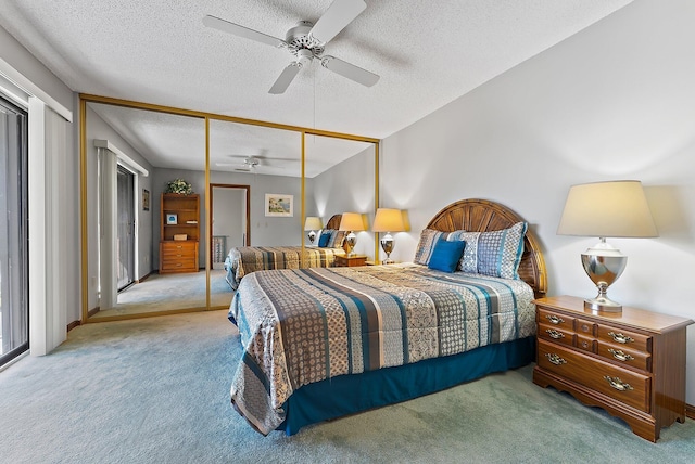 carpeted bedroom featuring ceiling fan, a closet, and a textured ceiling