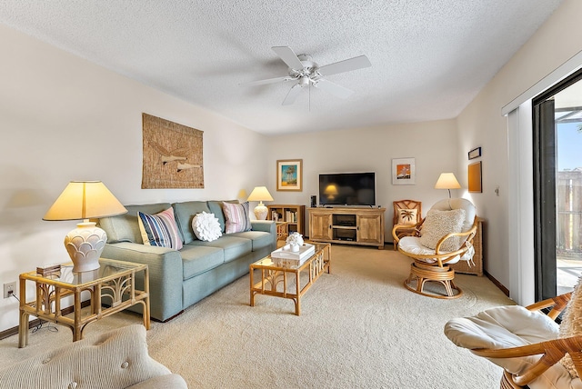 carpeted living room featuring ceiling fan, a textured ceiling, and baseboards