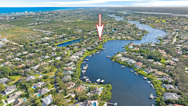 birds eye view of property with a water view and a residential view