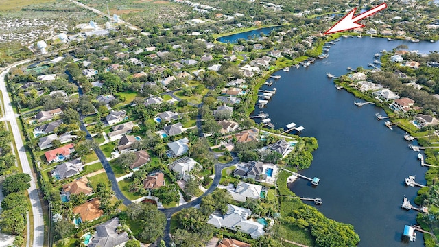 drone / aerial view featuring a residential view and a water view