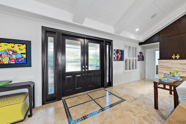 foyer featuring wooden ceiling, lofted ceiling with beams, and french doors