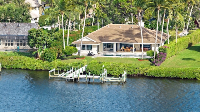 exterior space featuring a water view, an outdoor pool, boat lift, and a patio