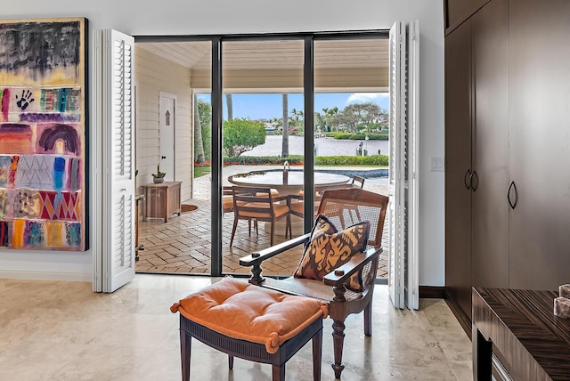 living area with a water view and baseboards