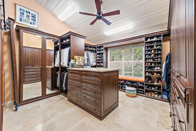 walk in closet featuring ceiling fan and lofted ceiling