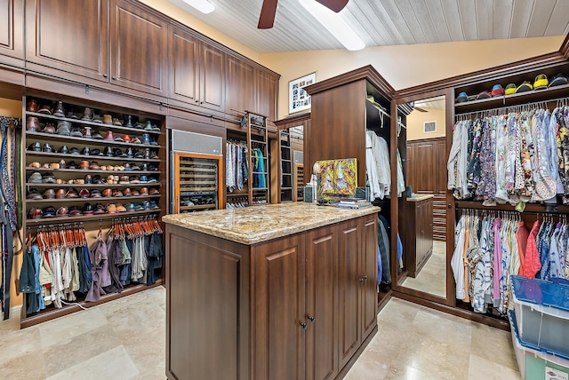 spacious closet featuring wine cooler, vaulted ceiling, and a ceiling fan