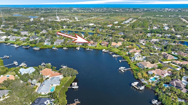 birds eye view of property with a water view and a residential view