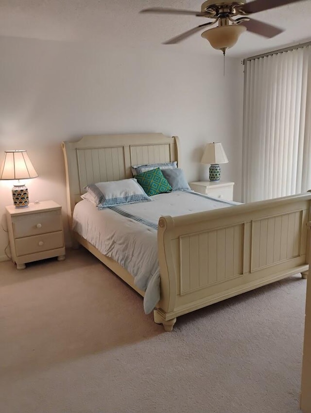 bedroom featuring light carpet and ceiling fan