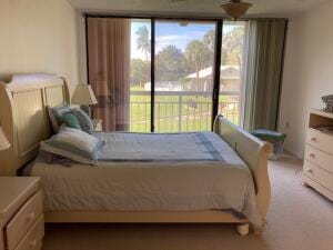 bedroom with access to exterior and carpet flooring