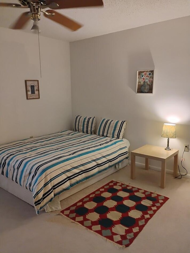 bedroom with ceiling fan and carpet