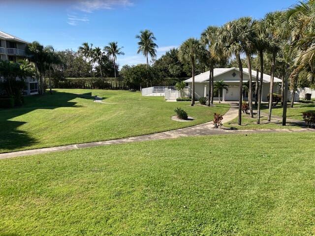 view of home's community with a yard