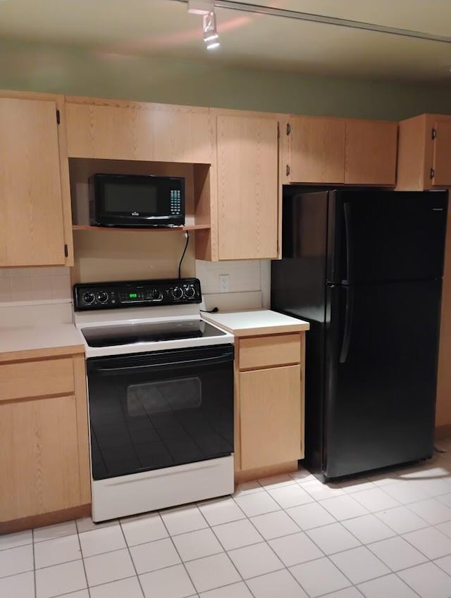 kitchen with light tile patterned floors, backsplash, light brown cabinets, track lighting, and black appliances