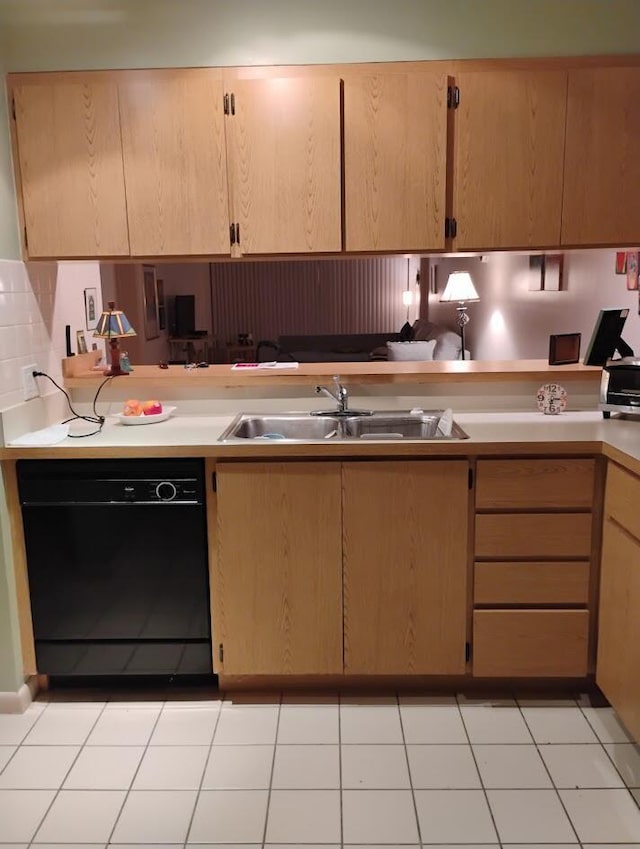 kitchen featuring light brown cabinetry, sink, black dishwasher, and light tile patterned flooring