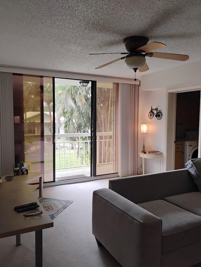 living room with a textured ceiling, ceiling fan, and washer / clothes dryer