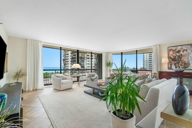 tiled living room featuring floor to ceiling windows and a water view