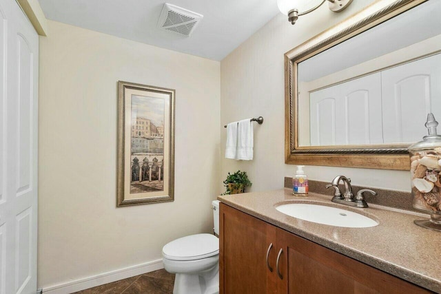 bathroom with toilet, tile patterned flooring, and vanity