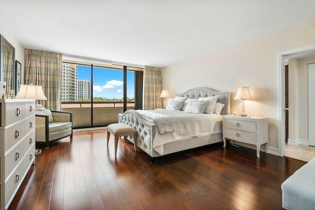 bedroom with dark hardwood / wood-style flooring and access to exterior