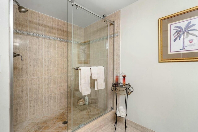 bathroom featuring a shower with door