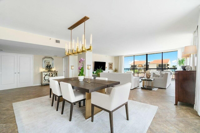 dining area with a chandelier and floor to ceiling windows