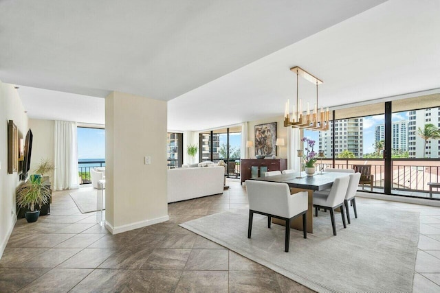 dining room with expansive windows and a chandelier