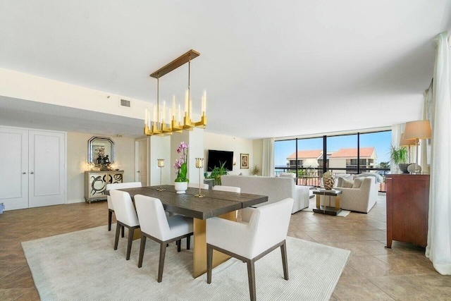 dining room with a chandelier and floor to ceiling windows