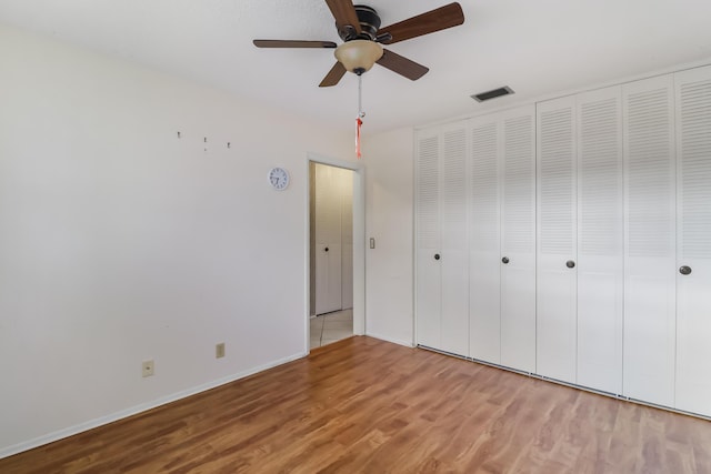 unfurnished room with ceiling fan and dark wood-type flooring