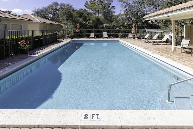 view of swimming pool with a patio area