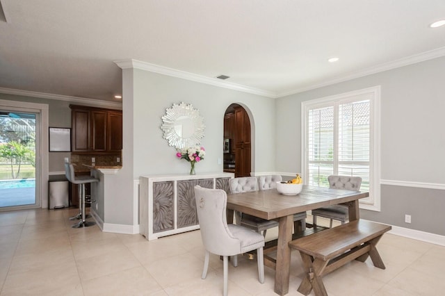 tiled dining room with crown molding