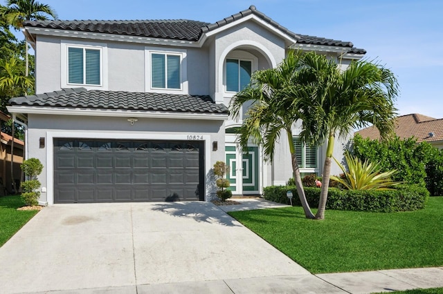 mediterranean / spanish house featuring a front yard and a garage