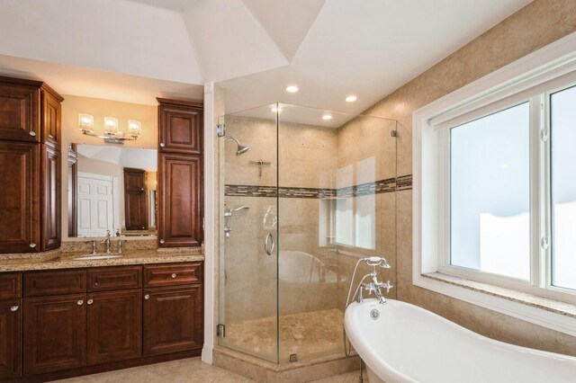 bathroom with vanity and separate shower and tub