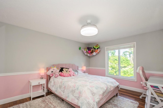 bedroom with dark hardwood / wood-style floors