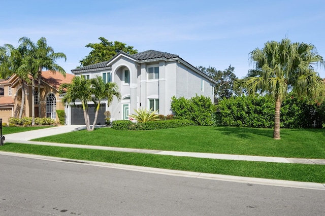 mediterranean / spanish-style house with a garage and a front yard