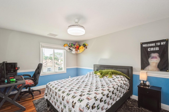 bedroom featuring dark hardwood / wood-style flooring