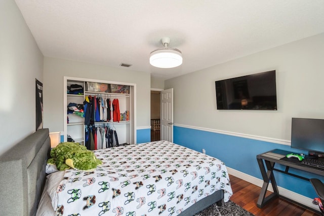 bedroom with a closet and hardwood / wood-style floors