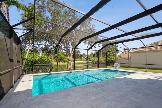 view of swimming pool featuring glass enclosure and a patio area