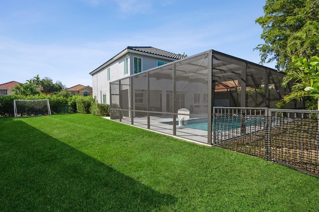 view of swimming pool with a patio area, a lanai, and a lawn