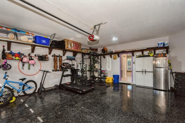 garage featuring stainless steel fridge and a garage door opener