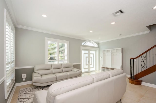 living room with crown molding, french doors, and light tile patterned floors