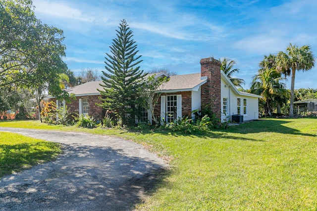 view of property exterior featuring a yard and central AC