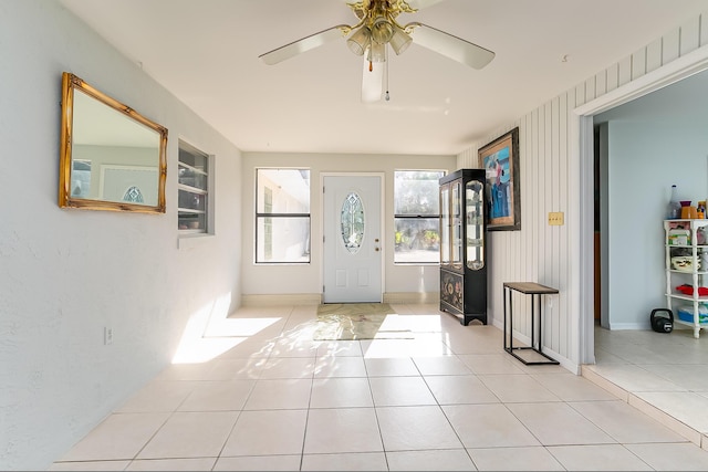 entrance foyer with ceiling fan and light tile patterned flooring