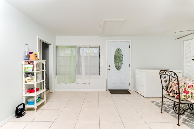 entrance foyer featuring light tile patterned floors and ceiling fan