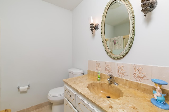 bathroom featuring tile patterned floors, vanity, and toilet