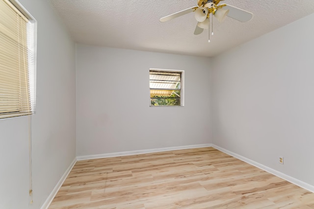 spare room featuring ceiling fan, light hardwood / wood-style flooring, and a textured ceiling