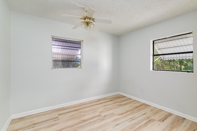 spare room featuring a textured ceiling, light hardwood / wood-style floors, and ceiling fan