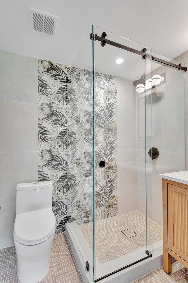 bathroom featuring vanity, tile walls, and walk in shower