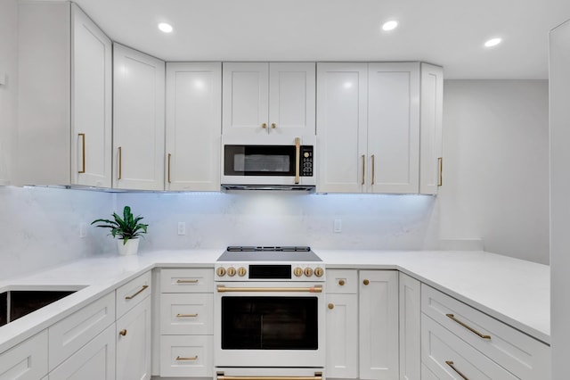 kitchen with decorative backsplash, high end stainless steel range, and white cabinets