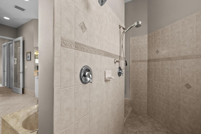 bathroom featuring tile patterned flooring and shower with separate bathtub