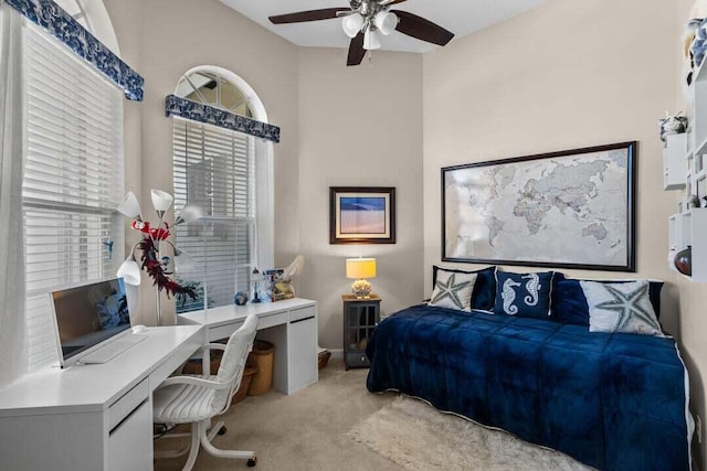 bedroom featuring light carpet and ceiling fan