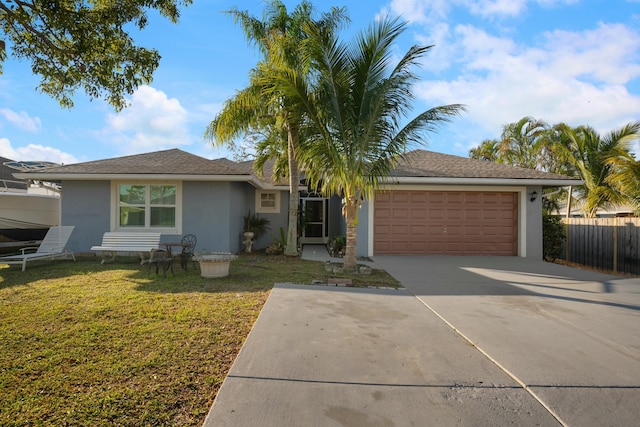 ranch-style house featuring a front yard and a garage