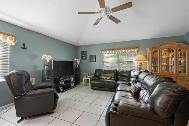 tiled living room with ceiling fan and lofted ceiling