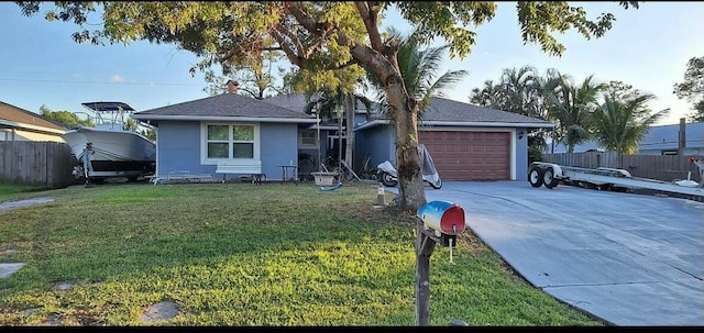 view of front of home with a garage and a front yard